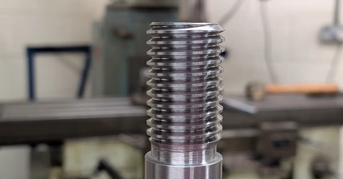 Close-up of a high-quality external thread on a metal part, showing clean and even machining